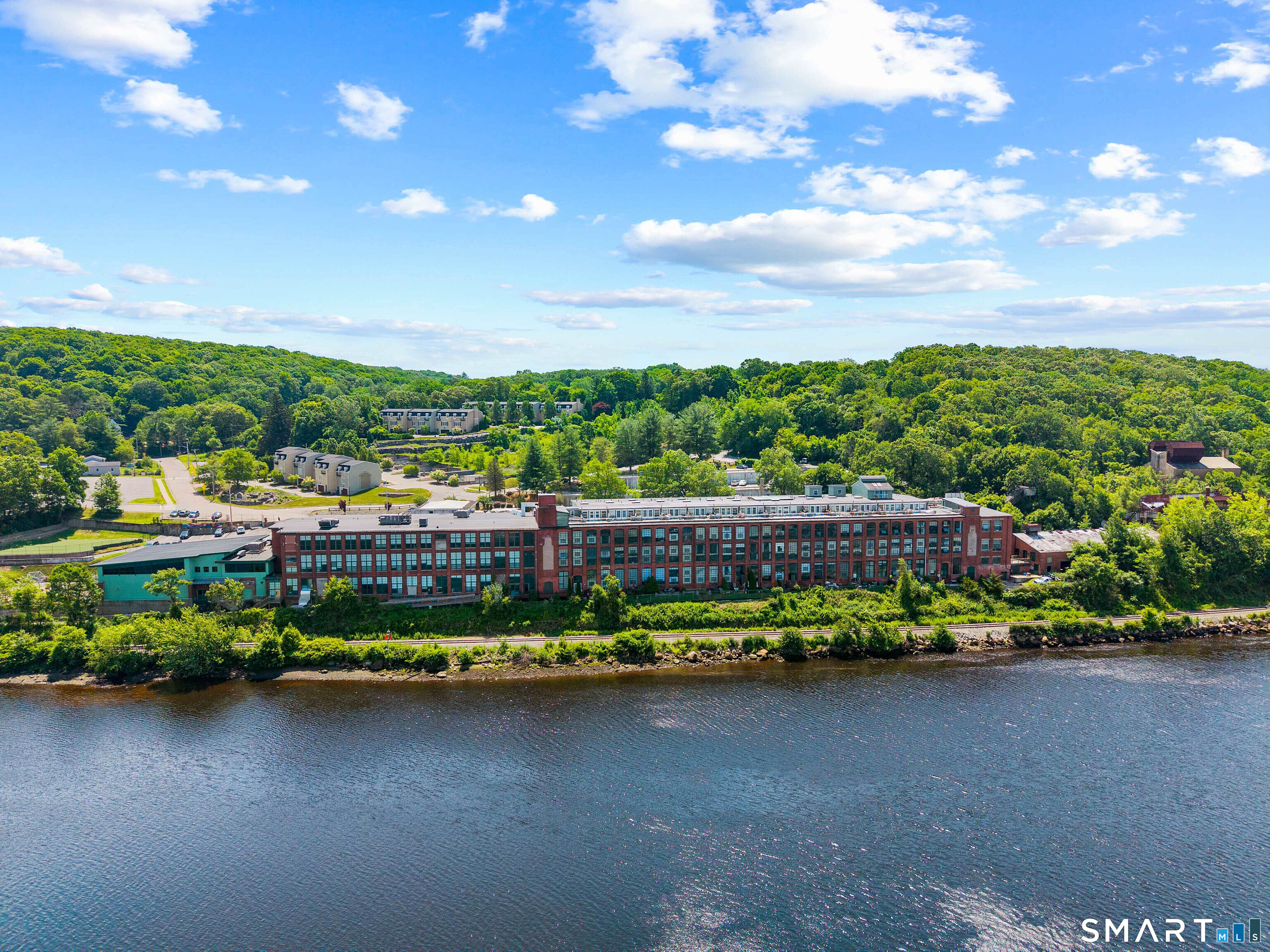 68 Thermos Avenue, Unit 110A Norwich, CT 06360 - Photo 3 of 39 a view of a city with lots of trees and houses in the background