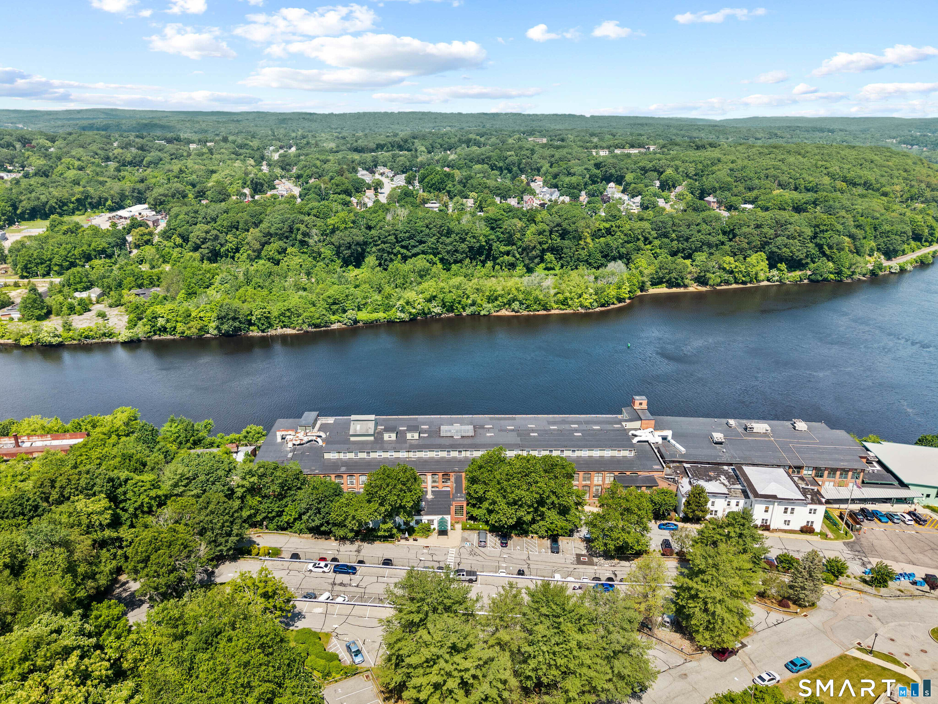 68 Thermos Avenue, Unit 110A Norwich, CT 06360 - Photo 32 of 39 an aerial view of a house with a yard and lake view