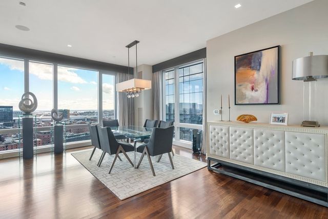 a living room with furniture fireplace and wooden floor