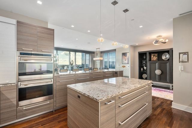 a kitchen with stainless steel appliances granite countertop a stove and a refrigerator