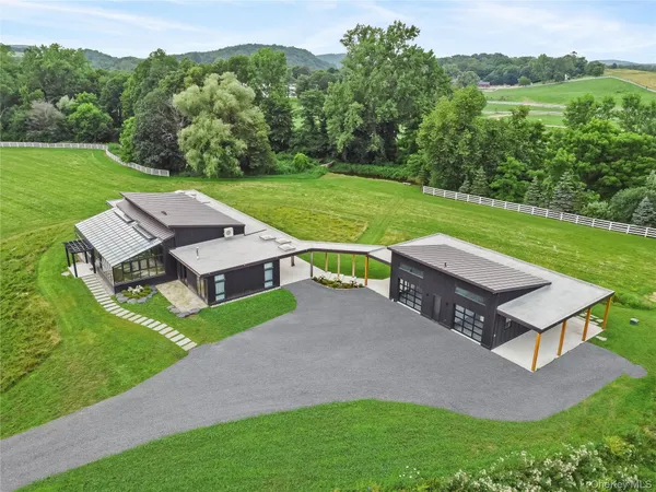 an aerial view of a house with a big yard