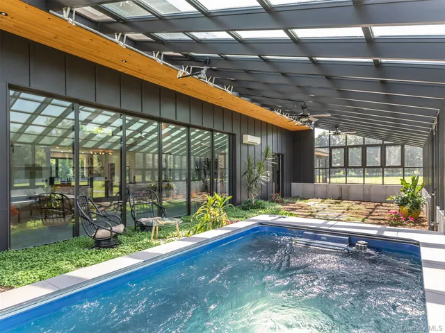 a building outdoor space with patio furniture and wooden floor