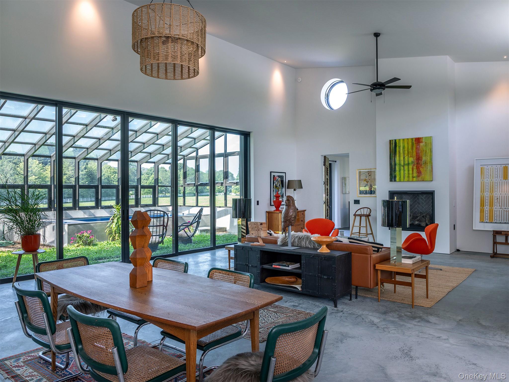476 Carpenter Hill Road Pine Plains, NY 12567 - Photo 17 of 50 Dining room featuring finished concrete floors, a towering ceiling, and ceiling fan
