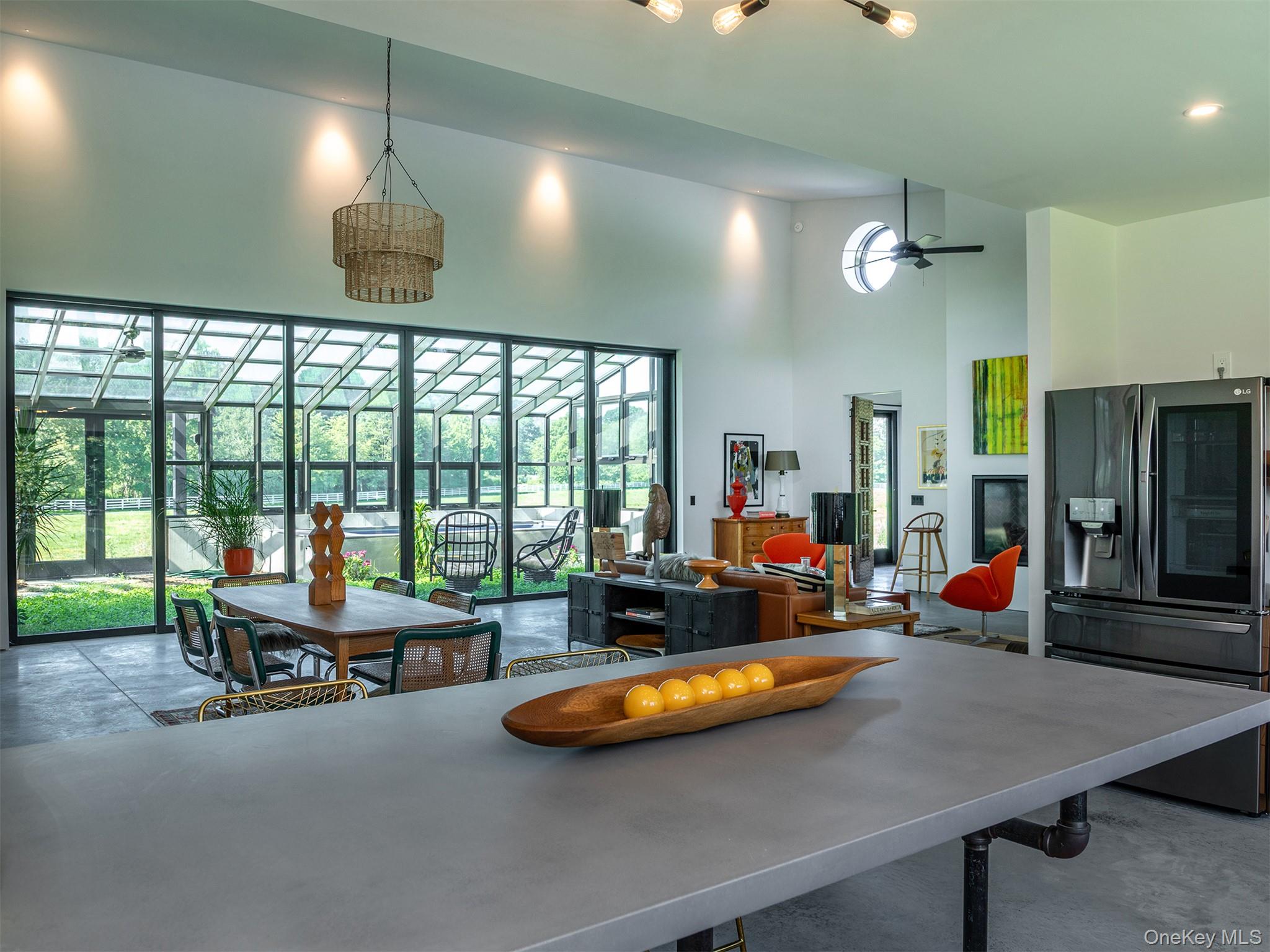 476 Carpenter Hill Road Pine Plains, NY 12567 - Photo 22 of 50 Kitchen featuring a towering ceiling, stainless steel fridge with ice dispenser, and finished concrete flooring