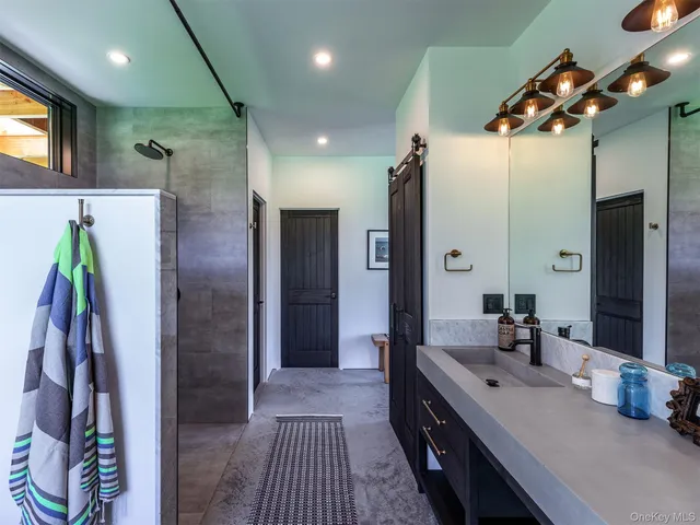 a bathroom with a double vanity sink and a mirror