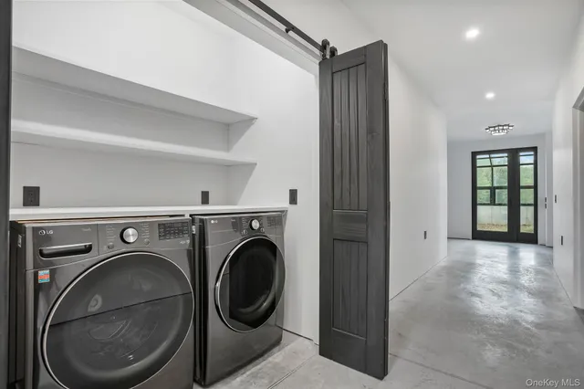 a view of a hallway with washer and dryer
