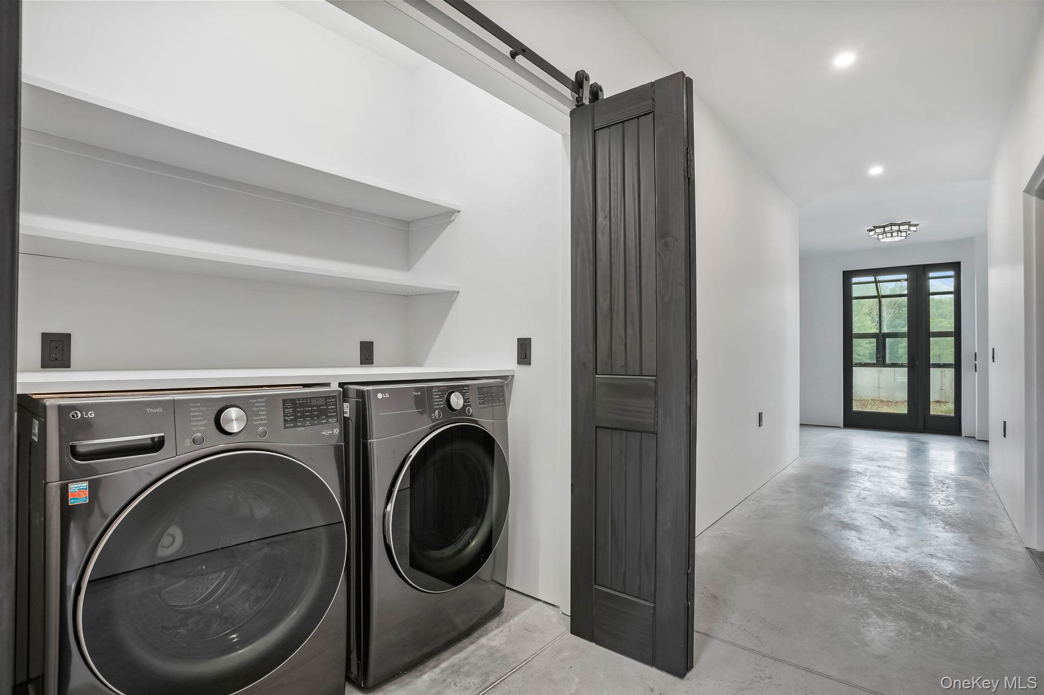 476 Carpenter Hill Road Pine Plains, NY 12567 - Photo 32 of 50 Laundry room with washing machine and dryer, a barn door, and recessed lighting