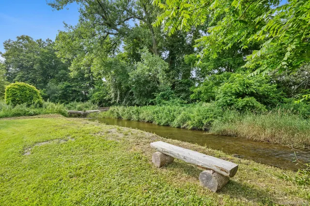 a view of a house with a yard and garage