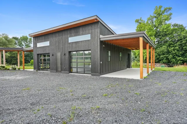 a living room with furniture a rug and kitchen view