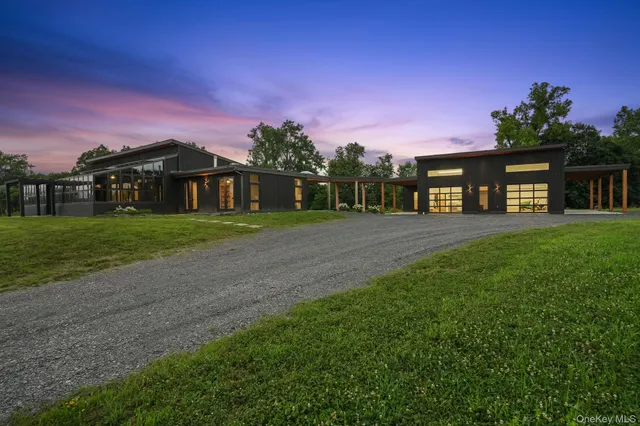 a view of a house with a yard and potted plants