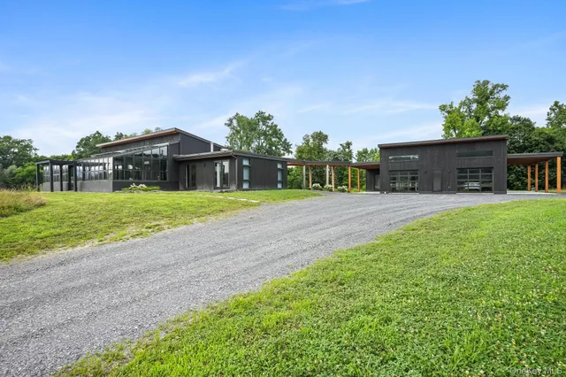 a view of a house with a yard and sitting area