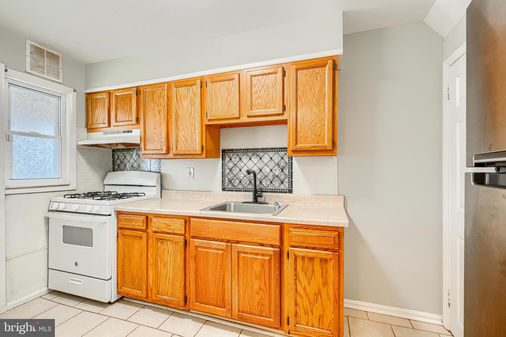 2073 Jasmine Road Baltimore, MD 21222 - Photo 9 of 29 a kitchen with white cabinets and white appliances