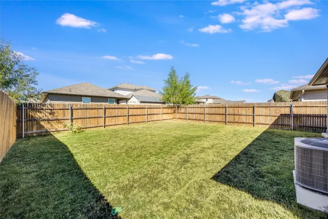 a view of house with a yard