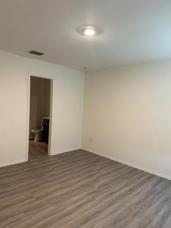 5906 Nyquist Way Forney, TX 75126 - Photo 19 of 27 Spare room featuring wood finished floors and a textured ceiling