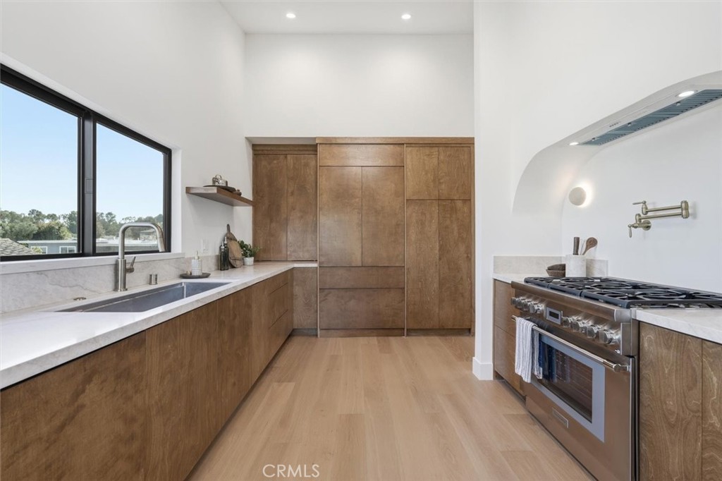 8140 Calabar Avenue Playa del Rey, CA 90293 - Photo 15 of 60 a large kitchen with stainless steel appliances granite countertop a lot of counter space and a sink
