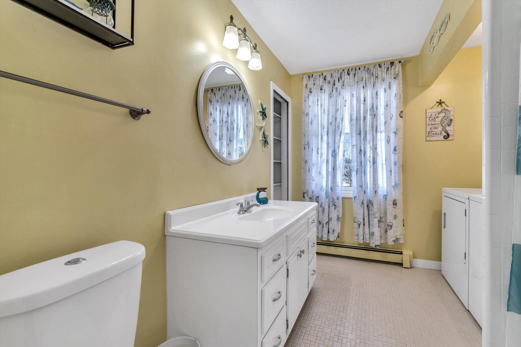 3 McNamara Road West Yarmouth, MA 02673 - Photo 33 of 45 a bathroom with a sink a toilet and a shower curtain