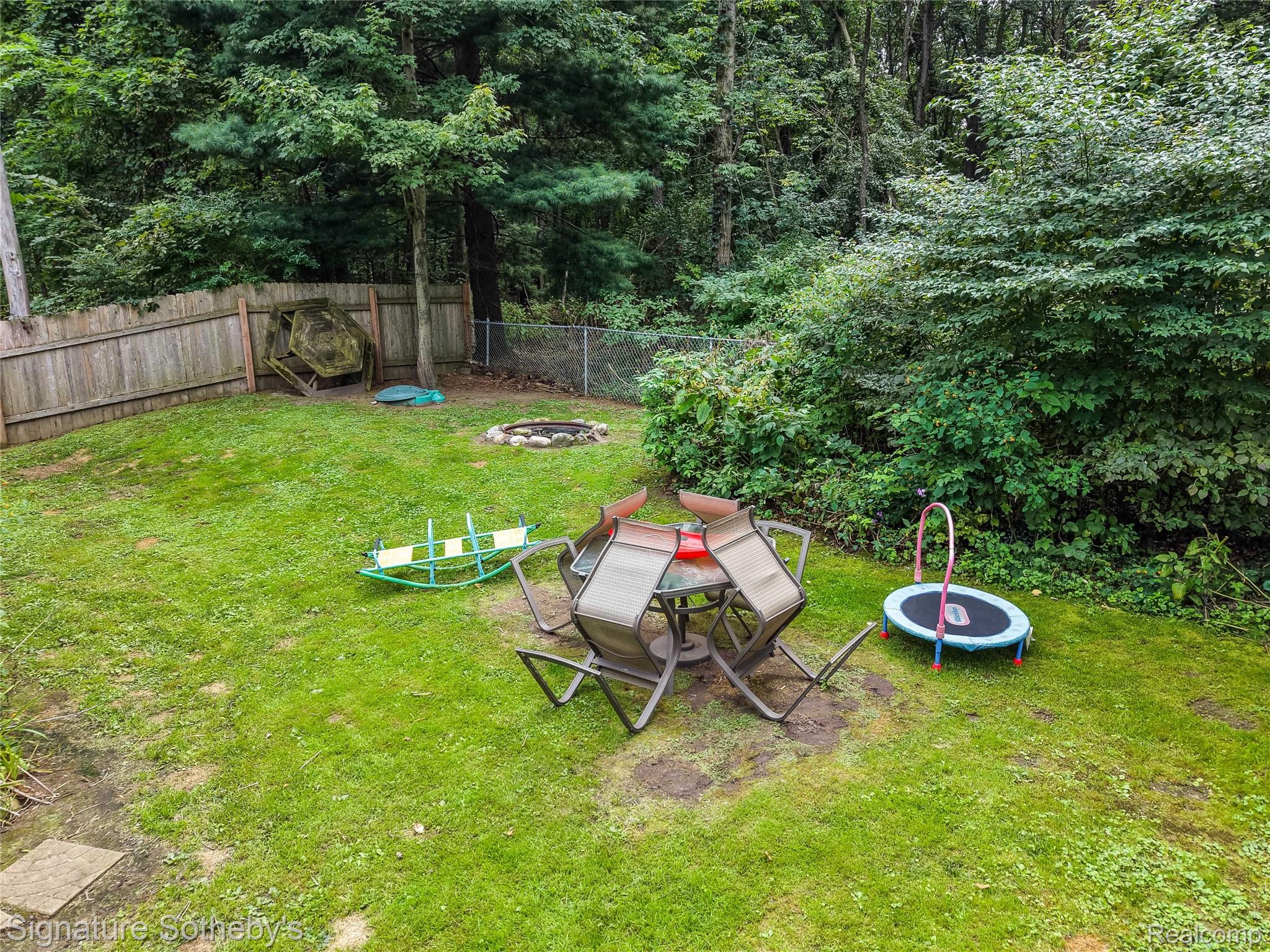 4137 West Allen Road Howell, MI 48855 - Photo 29 of 37 Spacious backyard with a wood privacy fence and a chain link fence