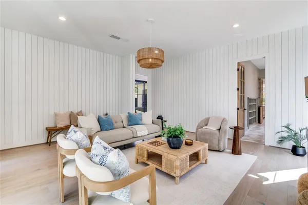 a living room with furniture and a clock
