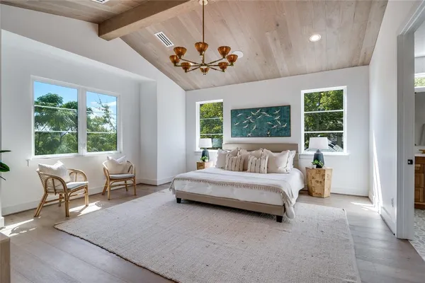 a spacious bedroom with a large bed and a couch