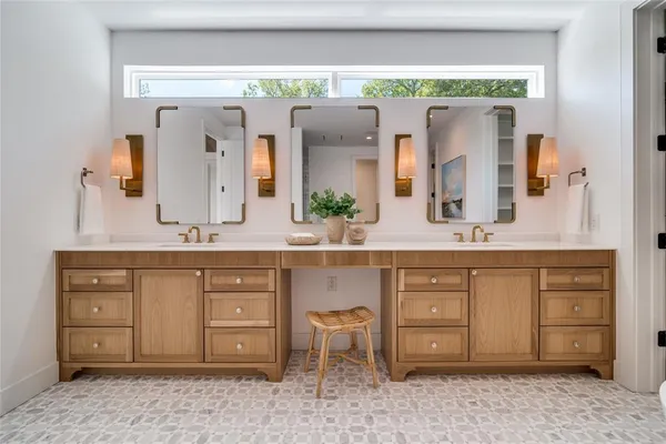 a bathroom with a double vanity sink and a mirror