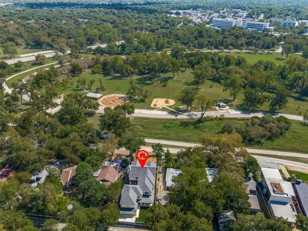 an aerial view of residential houses with outdoor space and swimming pool