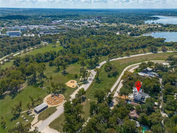an aerial view of a house with a yard