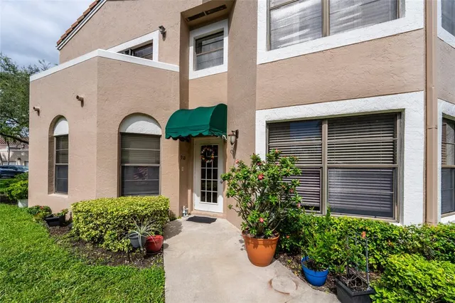 a front view of a house with potted plants