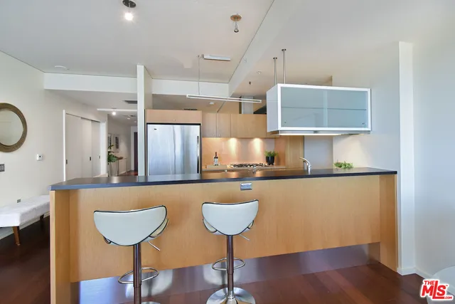 a bathroom with a granite countertop sink toilet a mirror a bathtub and shower