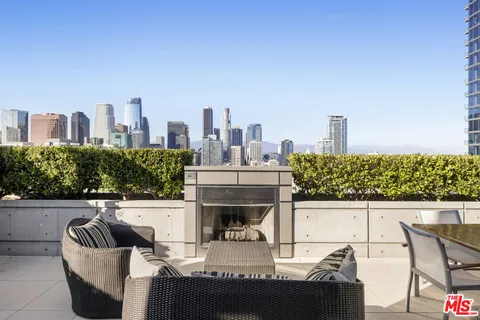 a view of roof deck with seating space and potted plants