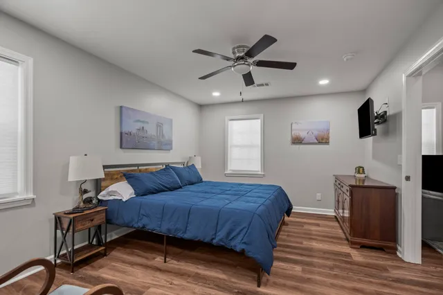 a bedroom with a bed and a flat screen tv