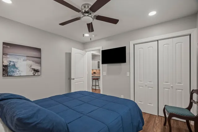 a bedroom with a bed and a flat screen tv