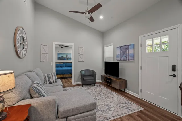 a living room with furniture a flat screen tv and a window