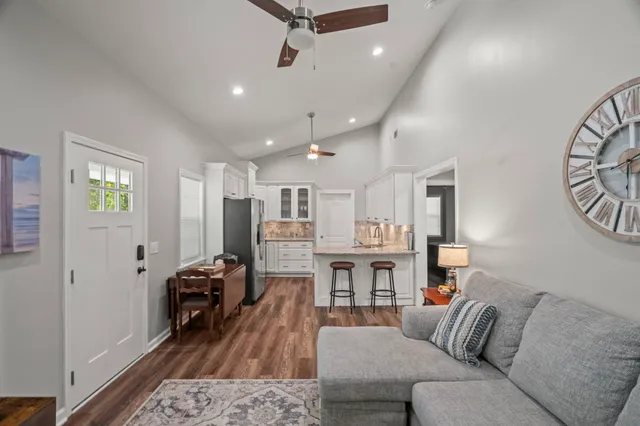 a living room with furniture and kitchen view