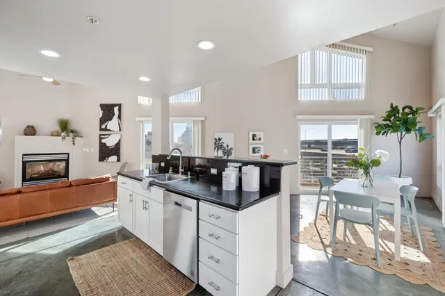 a kitchen with counter top space and windows