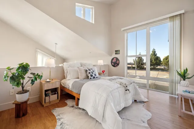 a bedroom with a bed and a potted plant