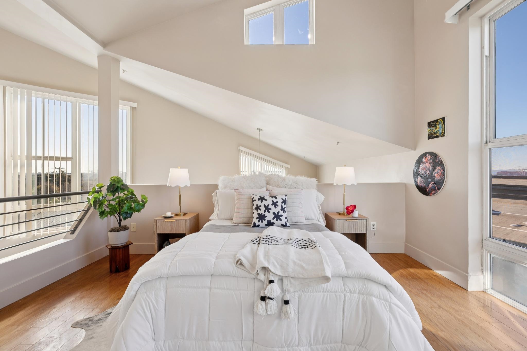 675 8th Street, Unit 10 Oakland, CA 94607 - Photo 24 of 40 a bedroom with bed and a large window