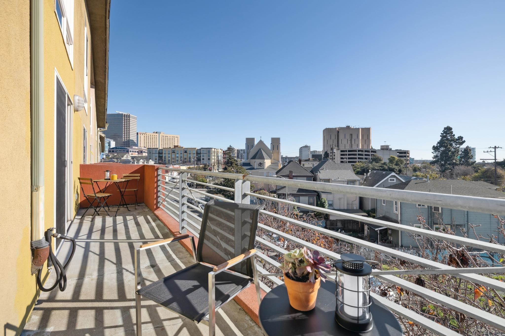 675 8th Street, Unit 10 Oakland, CA 94607 - Photo 27 of 40 a view of roof deck with two chairs and a potted plant