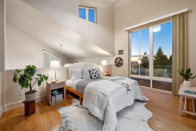 a bedroom with a bed and a potted plant