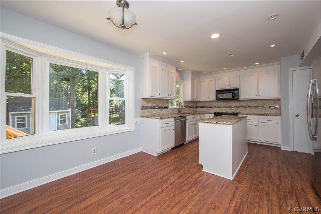 4915 Cedar Cliff Road Chester, VA 23831 - Photo 11 of 35 a kitchen with a refrigerator wooden floor and a window
