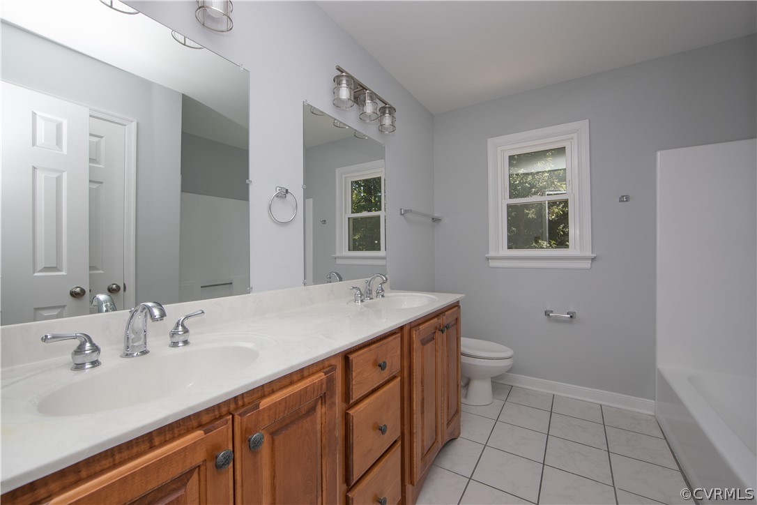 4915 Cedar Cliff Road Chester, VA 23831 - Photo 20 of 35 a bathroom with a sink toilet and mirror