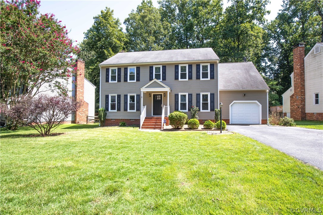 4915 Cedar Cliff Road Chester, VA 23831 - Photo 2 of 35 a front view of a house with a garden and trees