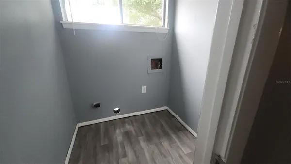 an empty room with a ceiling fan and a window
