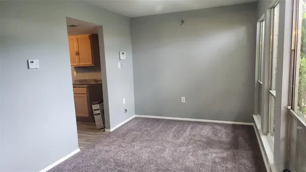 a kitchen with stainless steel appliances a refrigerator a stove a microwave with white cabinets and wooden floor