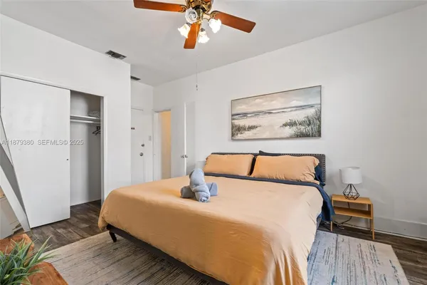 a bedroom with a large bed and a chandelier