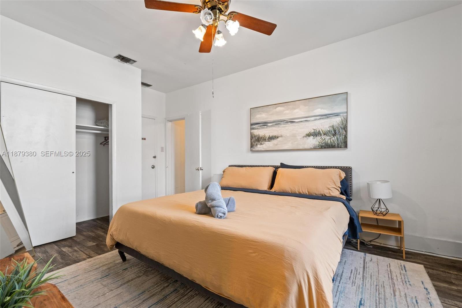 2453 Southwest 17th Street, Unit 2453 Miami, FL 33145 - Photo 12 of 22 a bedroom with a large bed and a chandelier