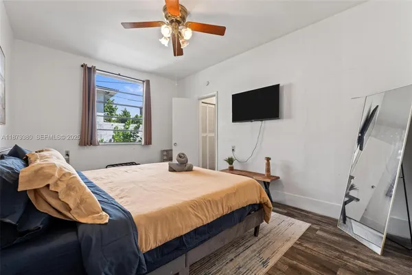 a bedroom with a bed and a flat screen tv