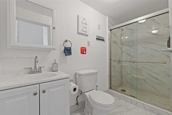 a white toilet sitting next to a bathroom sink