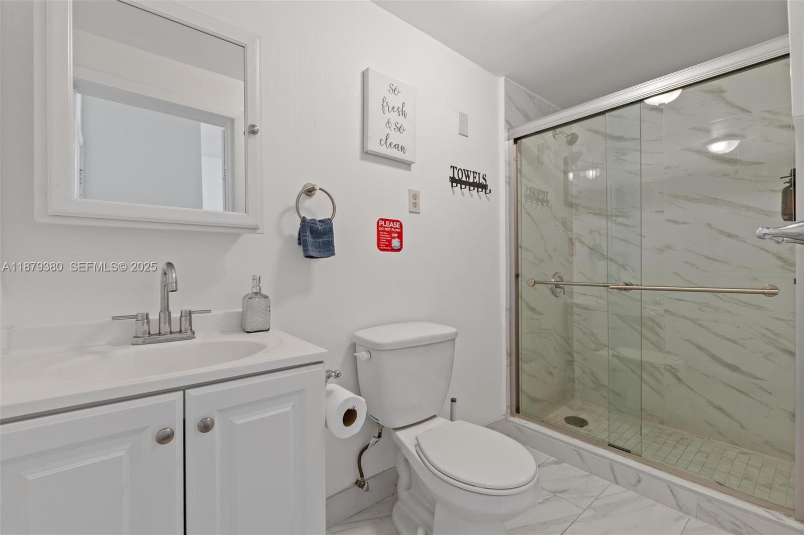 2453 Southwest 17th Street, Unit 2453 Miami, FL 33145 - Photo 14 of 22 a white toilet sitting next to a bathroom sink