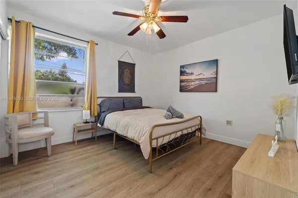 a bedroom with a bed and a painting on the wall