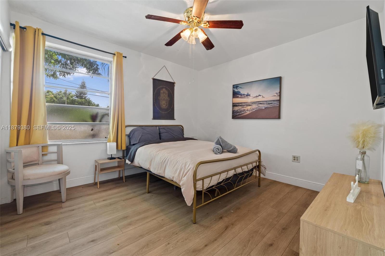 2453 Southwest 17th Street, Unit 2453 Miami, FL 33145 - Photo 15 of 22 a bedroom with a bed and a painting on the wall